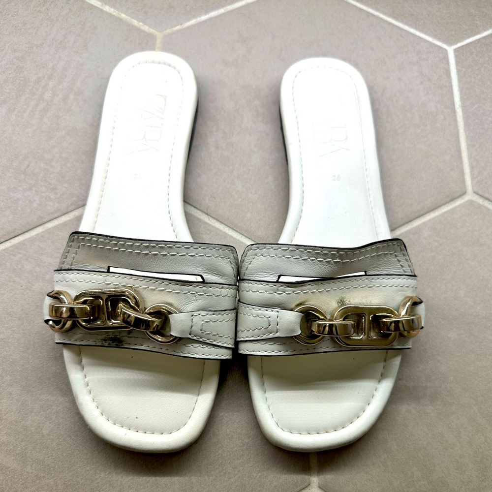 Zara white slippers with gold detail.